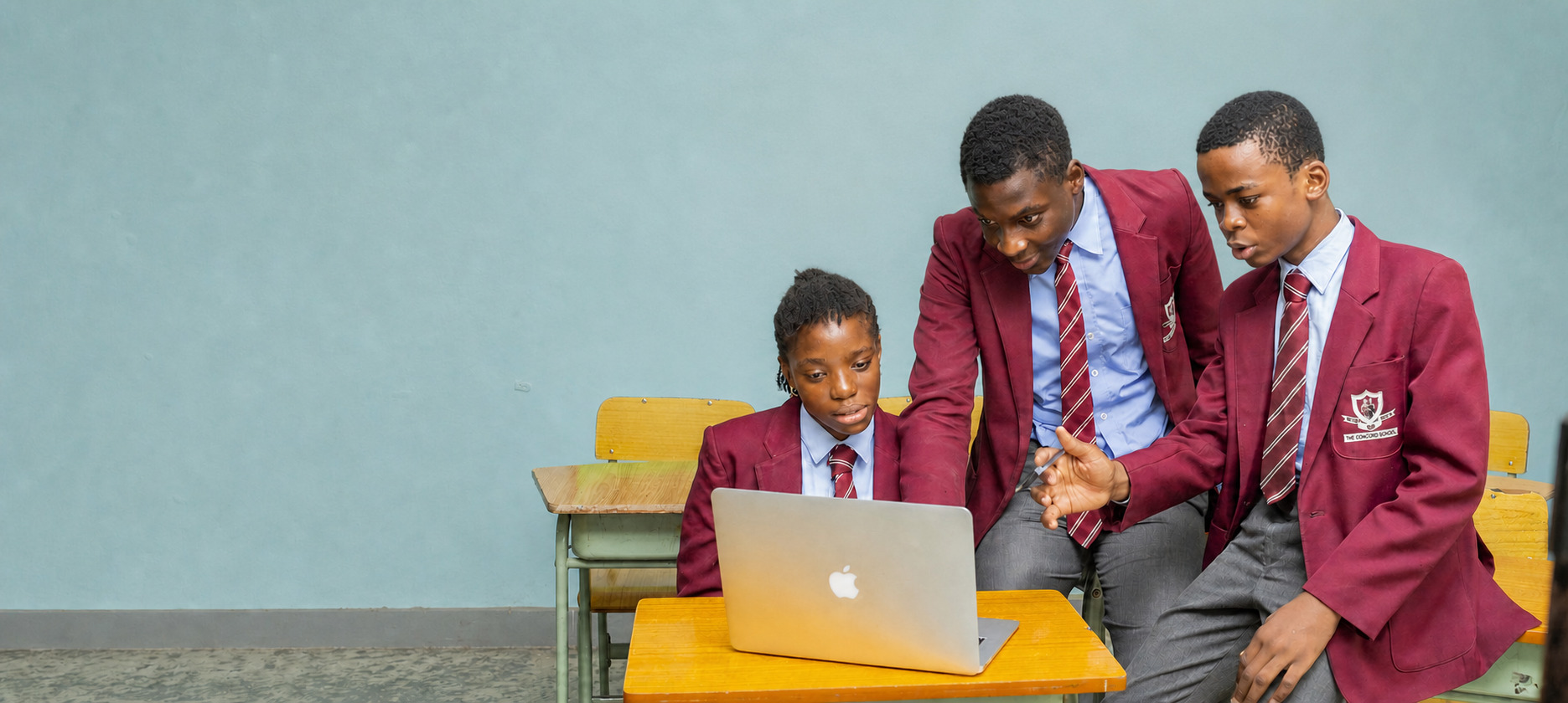Concord Senior School students collaborating around a laptop